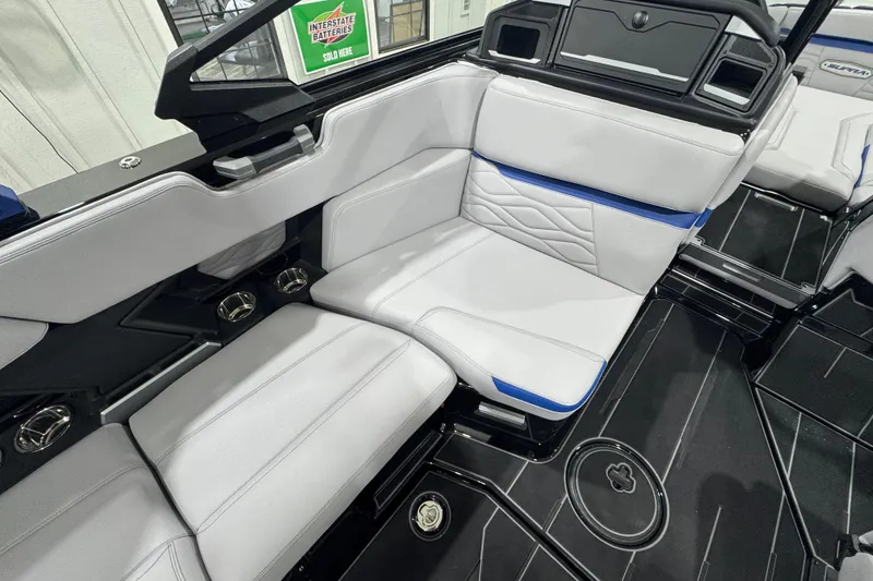Slide: The Image of 2026 Supra SL boat interior with sleek white and blue seating design. - 11