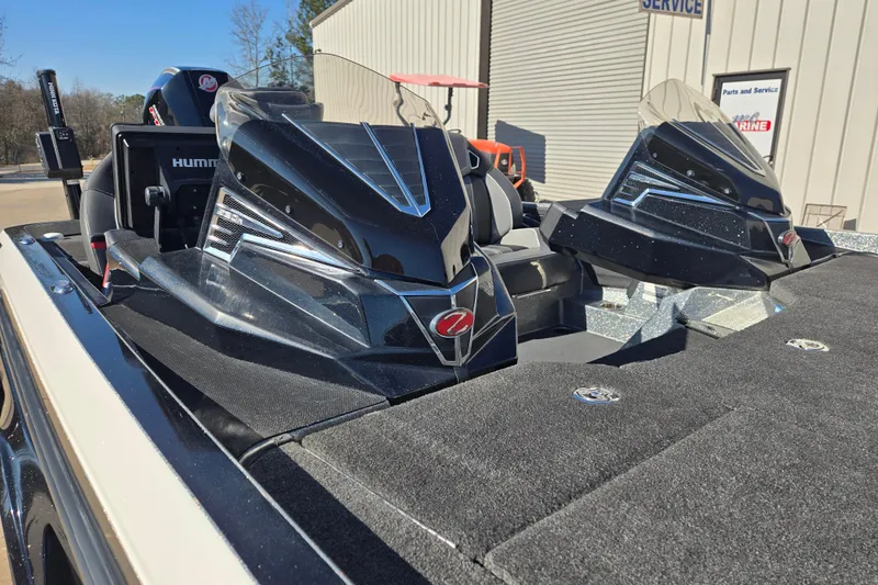 Slide: The Image of 2022 Ranger Z520R boat with sleek black design and advanced features, parked outdoors. - 14