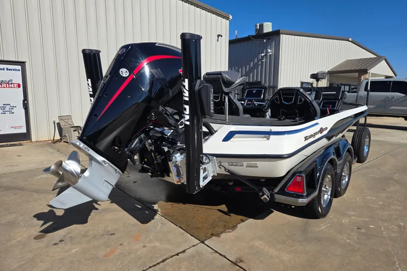 Slide: The Image of 2022 Ranger Z520R boat with powerful engine and sleek design, parked outside a building. - 3
