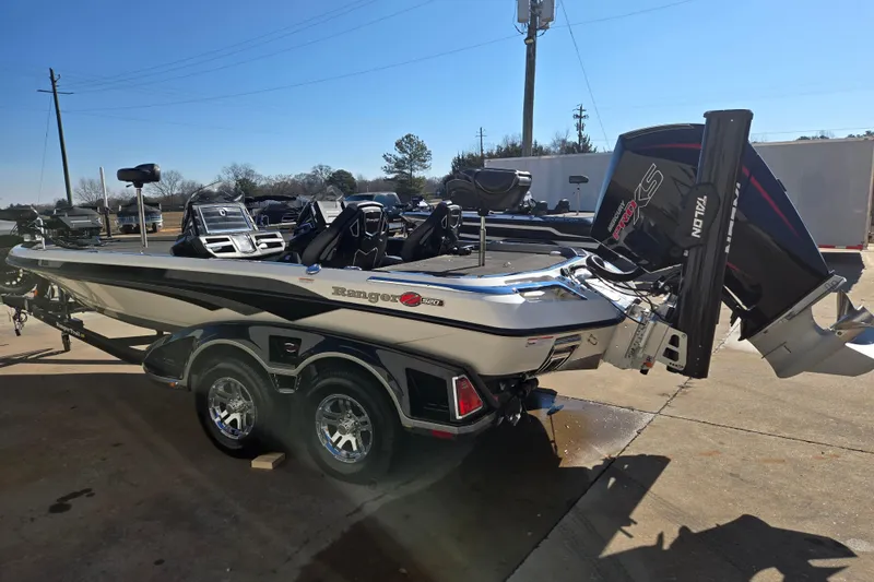 Slide: The Image of 2022 Ranger Z520R boat with dual axle trailer, parked outdoors on a sunny day. - 6