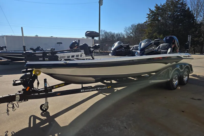 Slide: The Image of 2022 Ranger Z520R boat on trailer, parked outdoors, featuring dual engines and sleek design. - 7