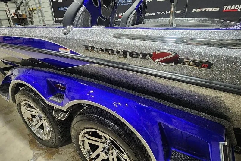 Slide: The Image of 2026 Ranger Z521R Cup-Equipped boat, metallic finish, close-up view of logo and wheels. - 13