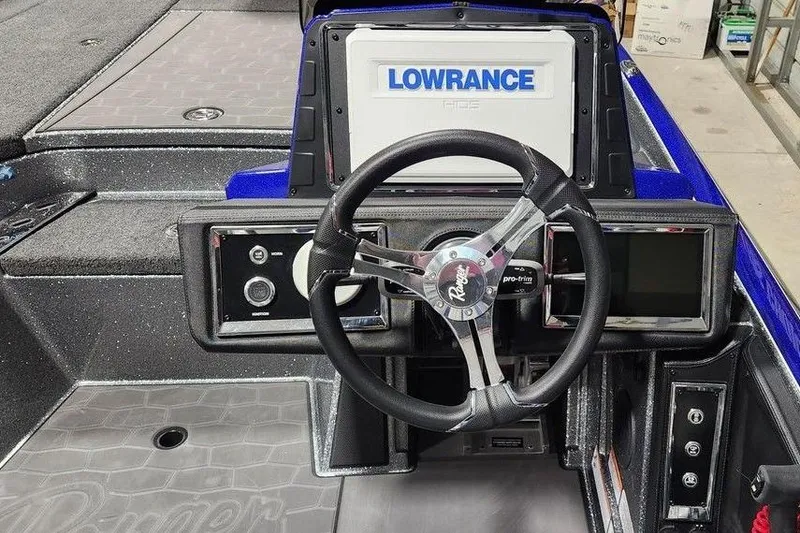 Slide: The Image of 2026 Ranger Z521R Cup-Equipped boat dashboard with Lowrance display and steering wheel. - 2