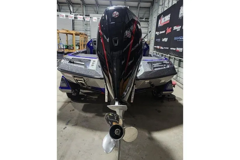 Slide: The Image of 2026 Ranger Z521R Cup-Equipped boat in a garage, rear view with motor. - 3