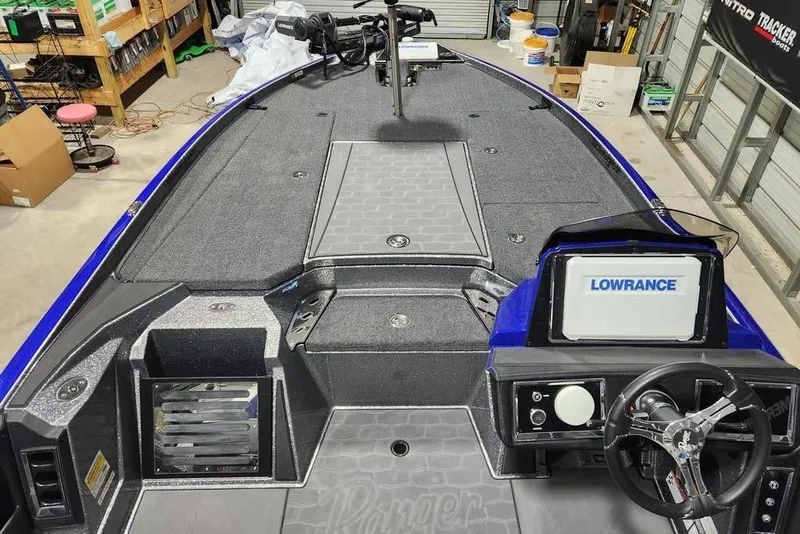 Slide: The Image of 2026 Ranger Z521R Cup-Equipped boat interior with Lowrance system, in a workshop setting. - 9