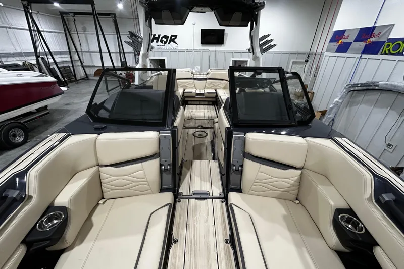 Slide: The Image of Luxurious 2026 Supra SE boat interior with beige seating and sleek design in a showroom. - 5