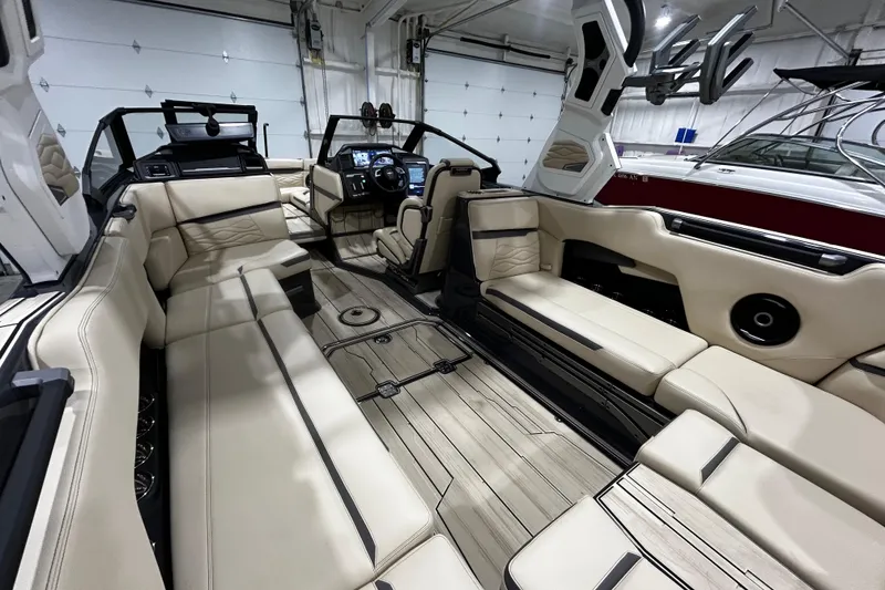 Slide: The Image of Luxurious interior of 2026 Supra SE boat with beige seating and modern dashboard. - 9