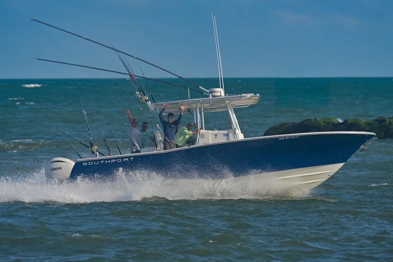 Slide: The Image of 2005 Southport 28 Center Console boat cruising on ocean with fishing rods. - 10