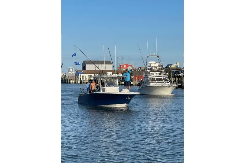Slide: The Image of 2005 Southport 28 Center Console boat on water with fishing rods and flags. - 11