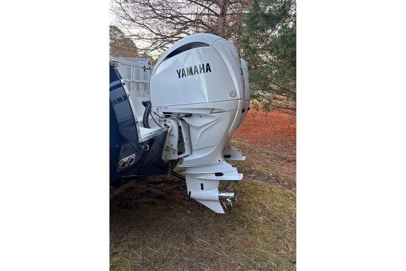 Slide: The Image of Yamaha outboard motor on 2005 Southport 28 Center Console boat, parked outdoors. - 13