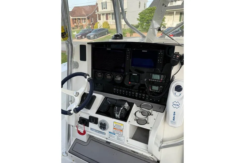 Slide: The Image of 2005 Southport 28 Center Console boat dashboard with steering wheel and navigation equipment. - 16