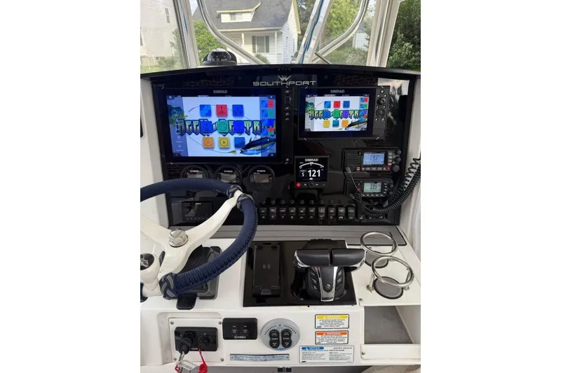 Slide: The Image of 2005 Southport 28 Center Console dashboard with modern navigation and control systems. - 18