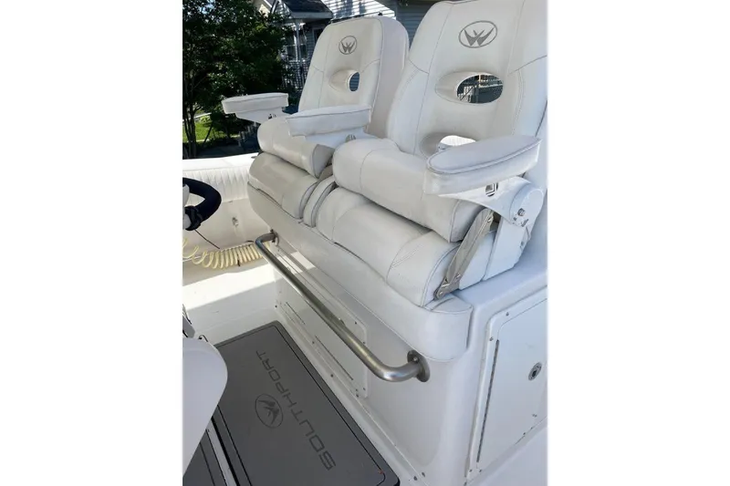 Slide: The Image of 2005 Southport 28 Center Console boat with white cushioned seating and armrests. - 24
