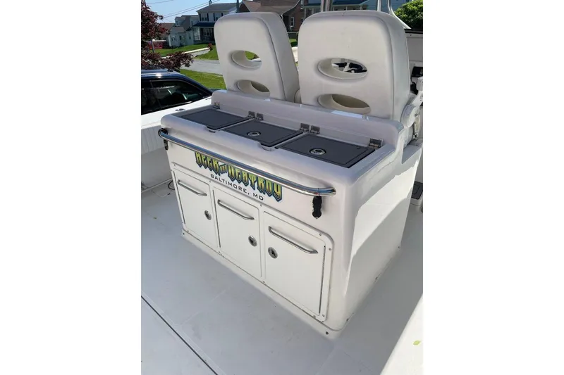 Slide: The Image of 2005 Southport 28 Center Console boat with dual seats and storage compartments. - 26