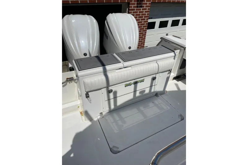 Slide: The Image of 2005 Southport 28 Center Console boat with dual Yamaha engines, docked near a brick building. - 27