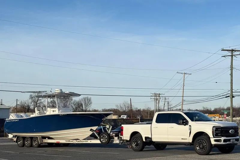 Slide: The Image of White truck towing a 2005 Southport 28 Center Console boat on a trailer. - 37