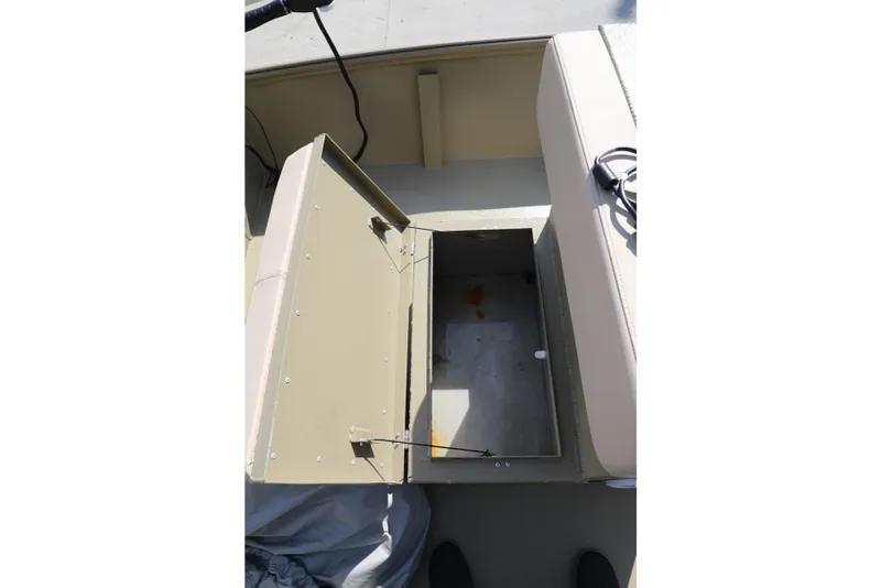 Slide: The Image of Open storage compartment in Xtreme 2072 boat, 2025 model, with beige interior. - 10