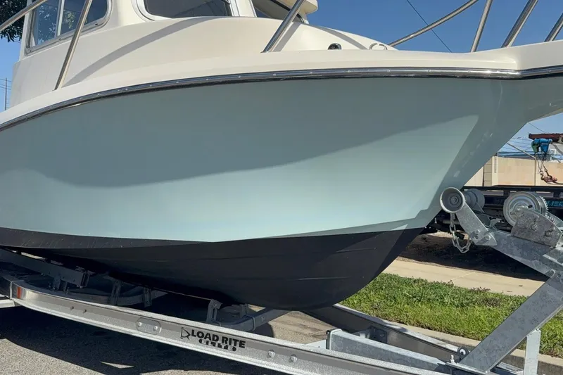 Slide: The Image of 2021 Defiance Admiral 220 EX boat on Load Rite trailer, side view. - 21