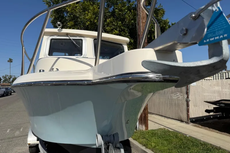 Slide: The Image of 2021 Defiance Admiral 220 EX boat with anchor, parked on street. - 22