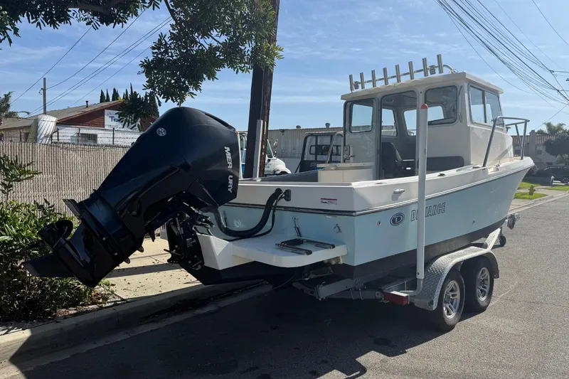 Slide: The Image of 2021 Defiance Admiral 220 EX boat on trailer with Mercury outboard motor. - 3