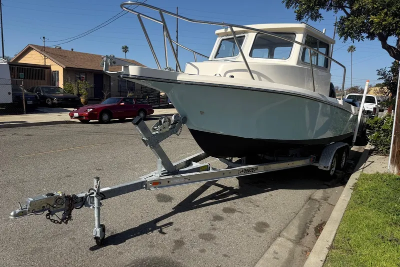 Slide: The Image of 2021 Defiance Admiral 220 EX boat on trailer parked on street. - 4