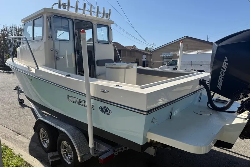 Slide: The Image of 2021 Defiance Admiral 220 EX boat on trailer with Mercury outboard engine. - 9