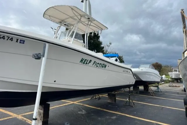 Slide: The Image of 2020 Cobia 237 Center Console boat on a parking lot. - 3