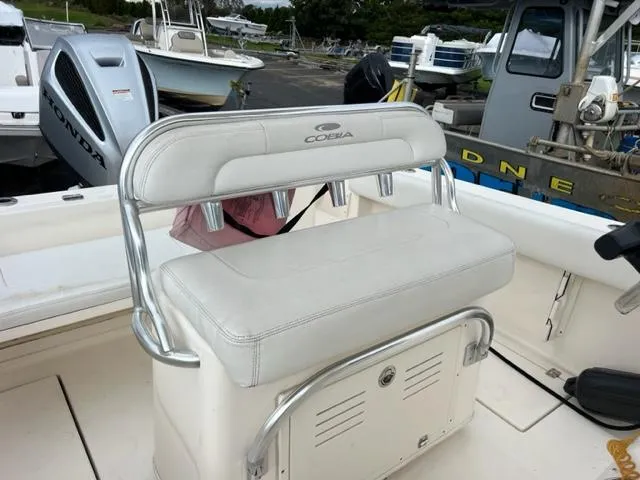 Slide: The Image of Cobia 237 Center Console 2020 with white seating and storage. - 5