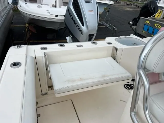 Slide: The Image of Cobia 237 Center Console 2020 with Honda engine, bench seat, and fishing rod holders. - 6