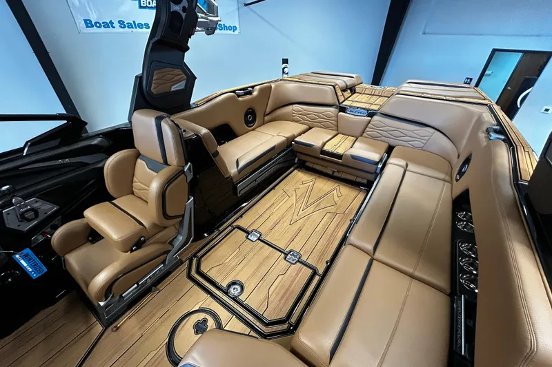 Slide: The Image of Luxurious interior of 2025 Supra SL boat with tan leather seating and wood flooring. - 7