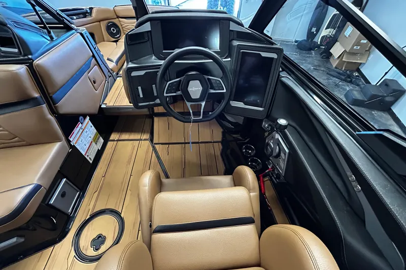 Slide: The Image of Interior of 2025 Supra SL boat with modern dashboard and tan leather seating. - 8