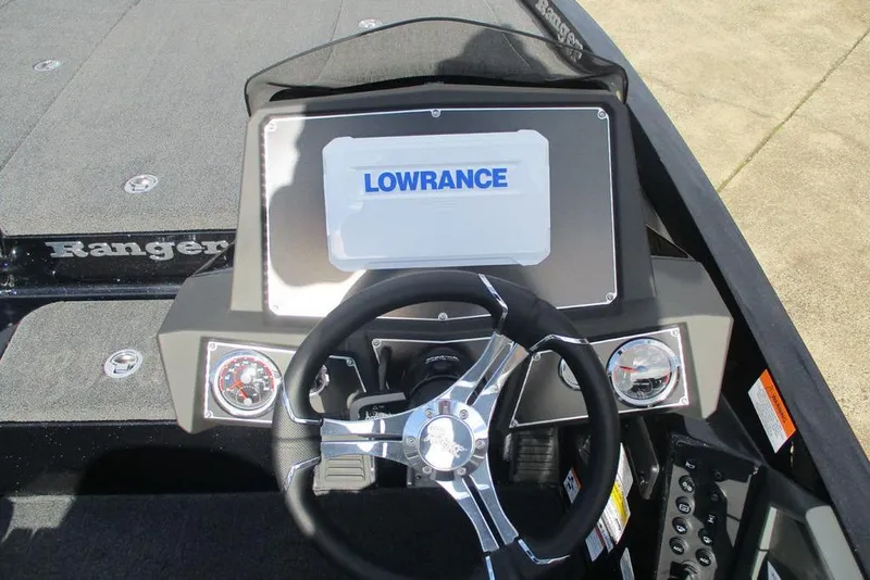 Slide: The Image of 2026 Ranger Z518 Cup-Equipped boat dashboard with Lowrance display and steering wheel. - 5