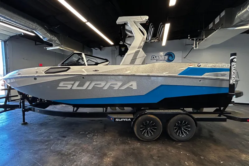 The Image of 2025 Supra SL boat in showroom, featuring sleek design and modern aesthetics. - 1