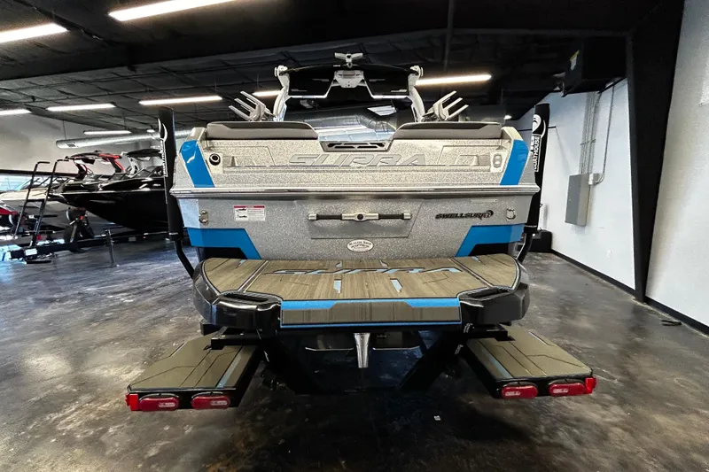 Slide: The Image of 2025 Supra SL boat rear view in showroom, featuring sleek design and modern features. - 3