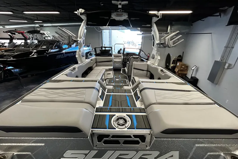 Slide: The Image of 2025 Supra SL boat interior with luxurious seating and modern design in showroom. - 4