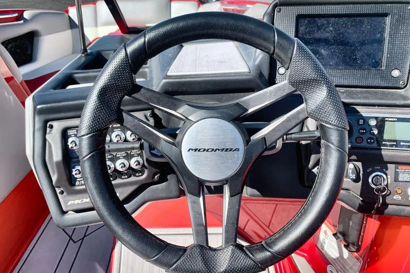 Slide: The Image of 2023 Moomba Mojo boat steering wheel and dashboard controls. - 14