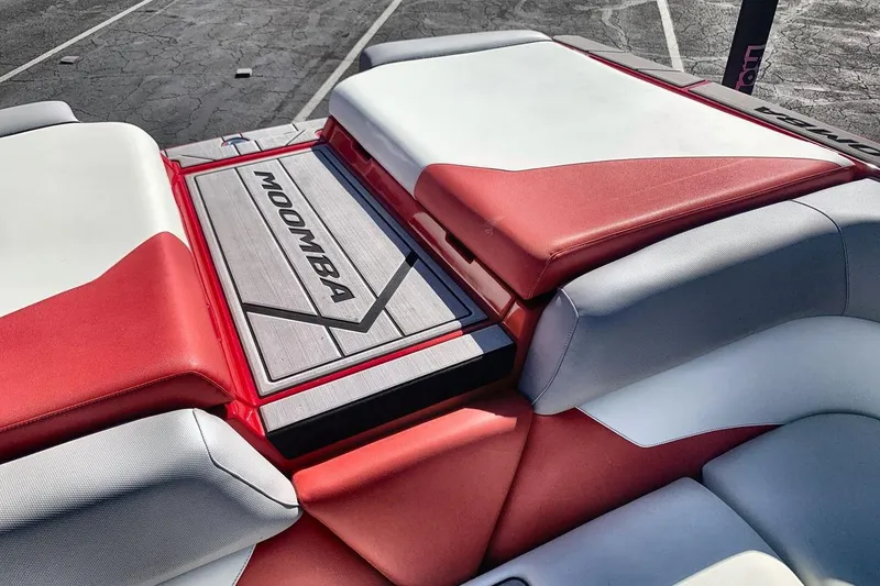 Slide: The Image of 2023 Moomba Mojo boat interior with red and white seating, showcasing brand logo. - 19