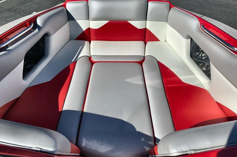 Slide: The Image of 2023 Moomba Mojo boat interior with red, white, and gray seating. - 11