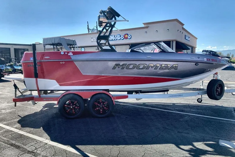Slide: The Image of 2023 Moomba Mojo boat on trailer in parking lot, sunny day. - 6