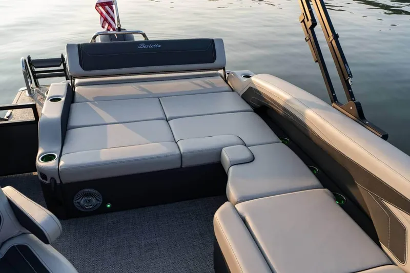 Slide: The Image of Manufacturer Provided Image: 2026 Barletta Cabrio 22U boat interior with luxurious seating and cup holders on a calm lake. - 7