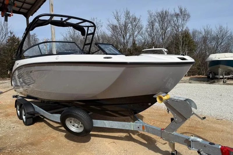 Slide: The Image of 2026 Yamaha Boats AR250 on trailer, parked outdoors, showcasing sleek design and modern features. - 2
