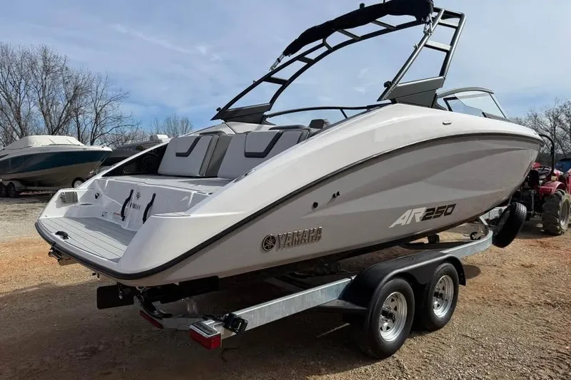 Slide: The Image of 2026 Yamaha Boats AR250 on trailer, sleek design, parked outdoors. - 4