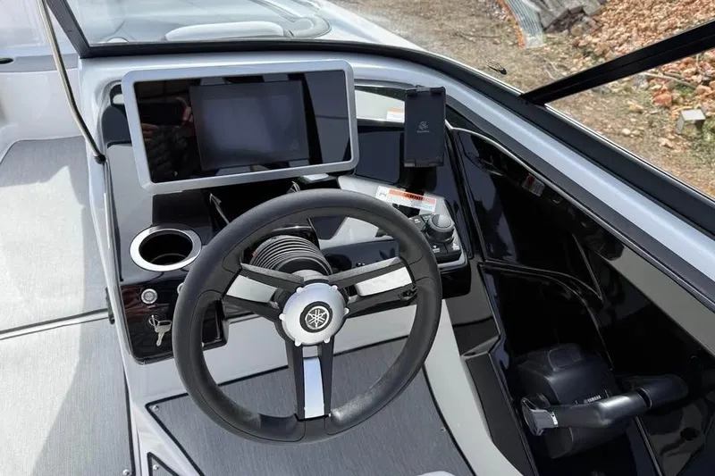 Slide: The Image of 2026 Yamaha Boats AR250 dashboard with steering wheel and touchscreen display. - 9