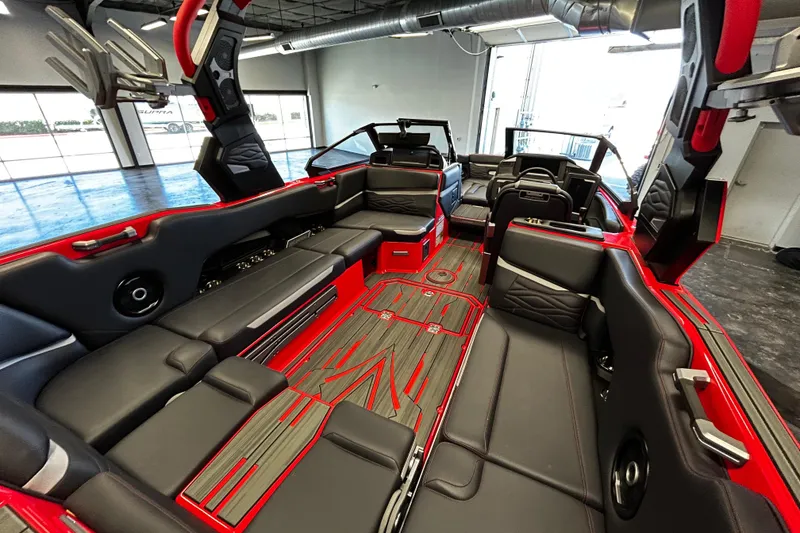 Slide: The Image of 2025 Supra SL boat interior with sleek black seating and red accents. - 5