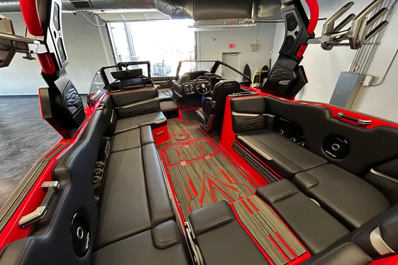 Slide: The Image of 2025 Supra SL boat interior with sleek black and red seating, modern design, and advanced features. - 6