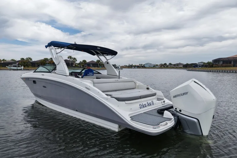 The Image of 2020 Sea Ray SDX 270 Outboard boat on calm water, featuring a Mercury engine. - 0