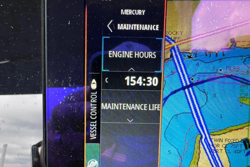 Slide: The Image of Display screen showing engine hours and navigation map on a 2020 Sea Ray SDX 270 Outboard. - 11