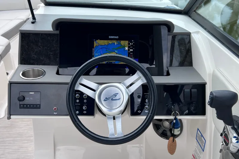 Slide: The Image of 2020 Sea Ray SDX 270 Outboard dashboard with steering wheel and navigation display. - 16