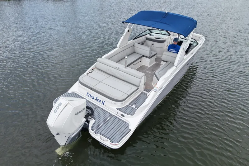 Slide: The Image of 2020 Sea Ray SDX 270 Outboard boat with blue canopy on calm water. - 2