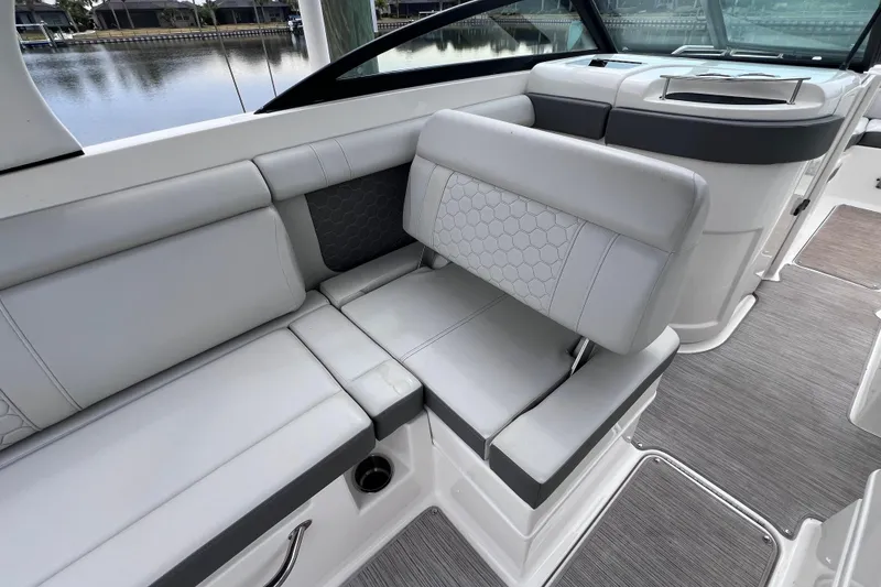 Slide: The Image of 2020 Sea Ray SDX 270 Outboard interior with gray seating and modern design. - 27